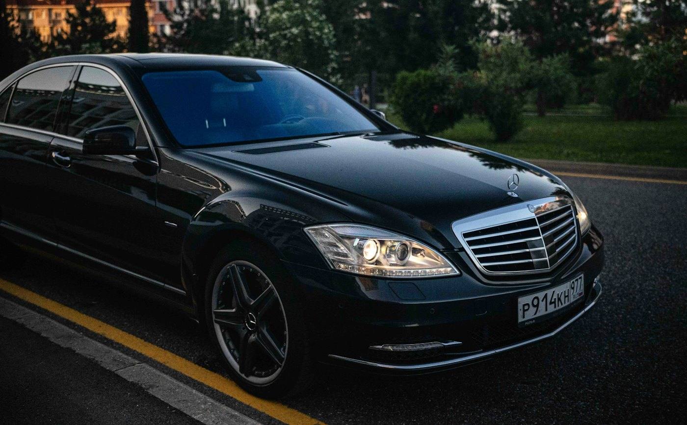 A dark sedan on an open road
